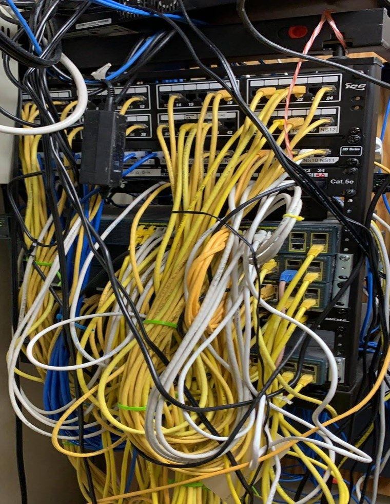 Tangled, unlabeled cabling before cleanup