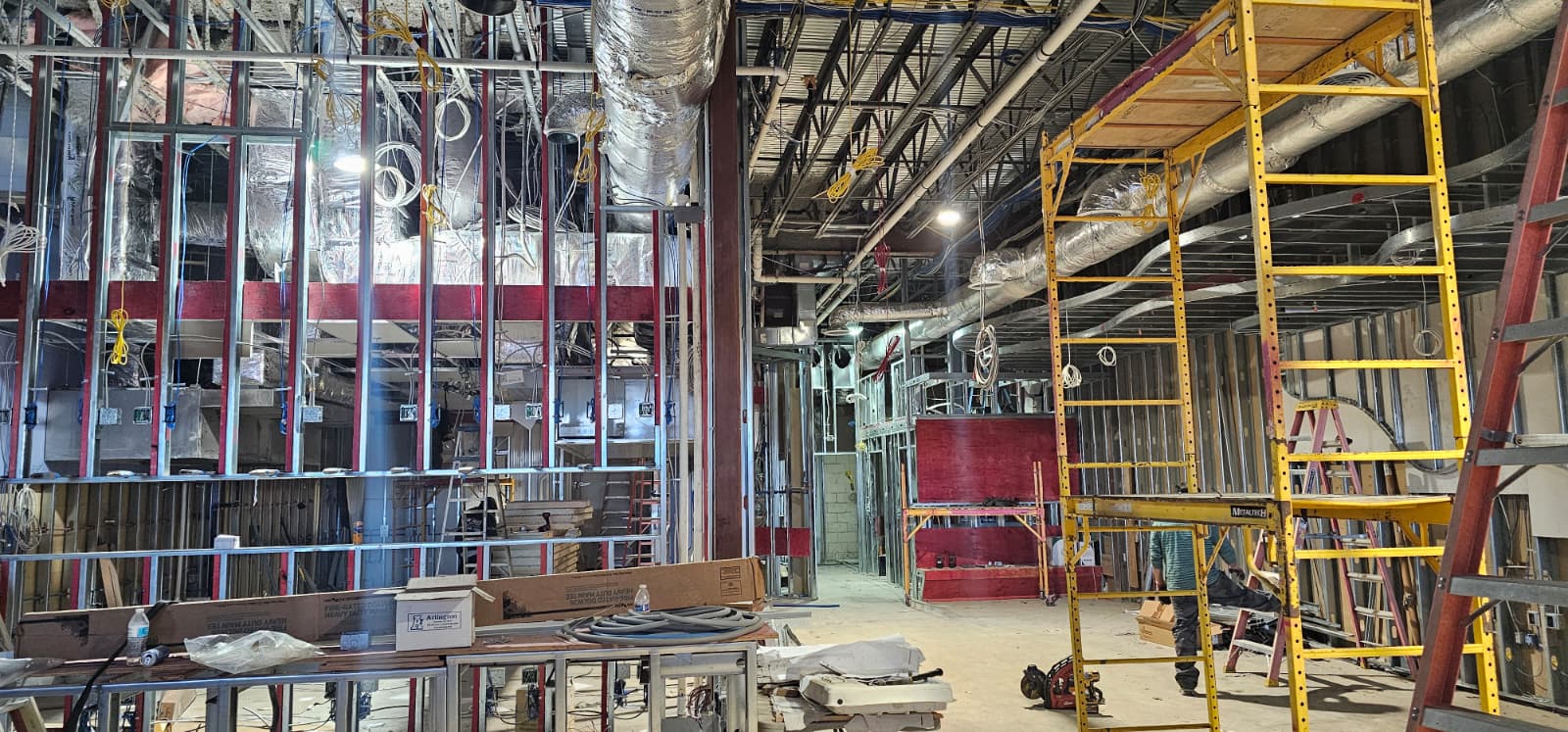 Restaurant interior during construction - open steel framing and ceiling before drywall