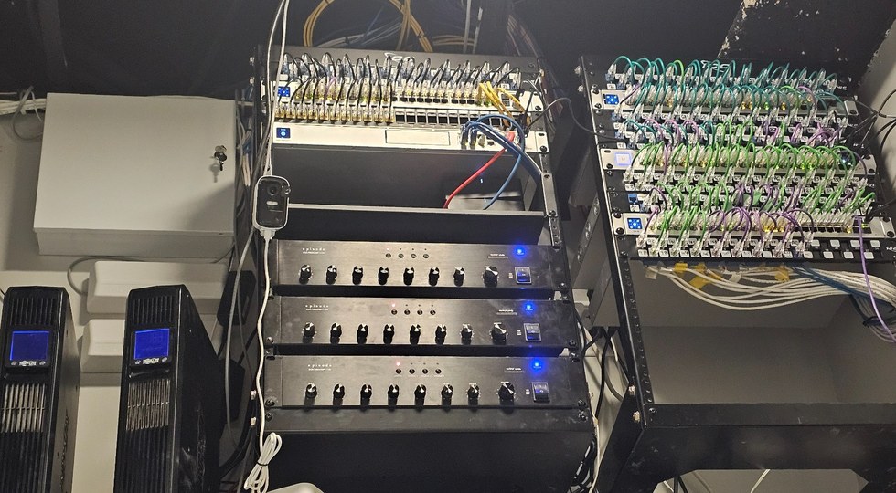 Organized rack after the upgrade, with labeled managed switches and color-coded patch cabling